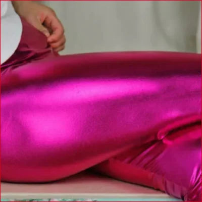 Vibrant fuchsia shiny disco pants women’s for a Studio 54-style look