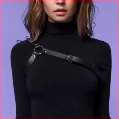 Black faux leather harness strap over turtleneck sweater for steampunk goth style