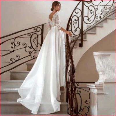 Elegant Satin Bridal Gown in White with Lace Sleeves and Flowing Skirt