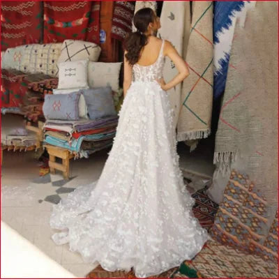 Elegant white lace spaghetti strap wedding dress with a flowing train for brides