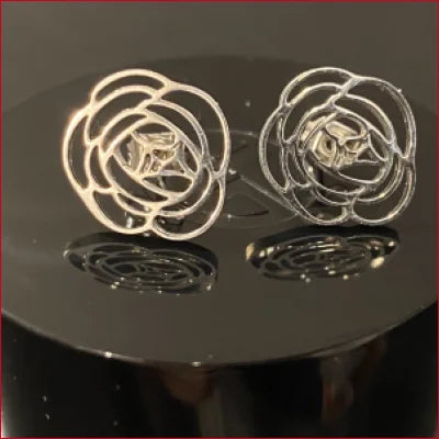 Pair of rose-shaped stainless steel stud earrings in silver and gold tones