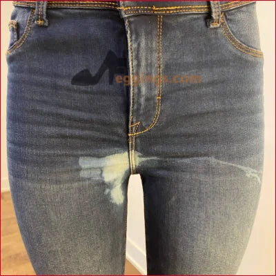 Pair of faded blue jeans with distressing in Stained Women’s Pencil Blue Jeans style