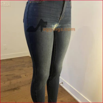 Pair of blue jeans on woman, featuring a unique design in stained women’s pencil style