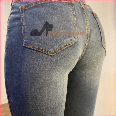 Pair of blue jeans featuring high-heeled shoe silhouette on back pocket for a unique style