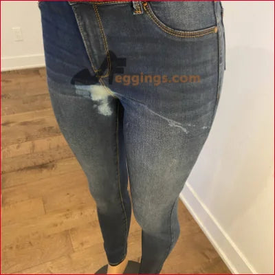 Pair of worn blue jeans with faded areas in Stained Women’s Pencil style for a unique look