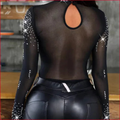 Sheer black bodysuit with sparkly embellishments for leather leggings styled look