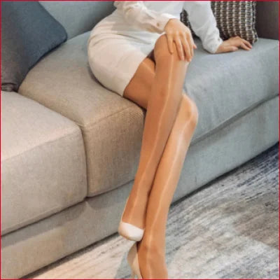 Pair of tanned legs in white heels showcasing Sheer Pantyhose Set for wedding dress lingerie