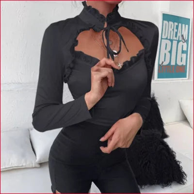 Black long-sleeved turtleneck crop top blouse with heart-shaped cutout and bow