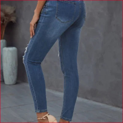 Pair of fitted dark blue figure-sculpting denim jeans worn by a person