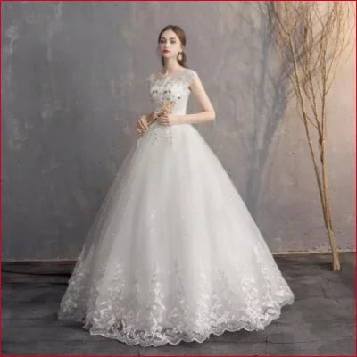 Elegant white bridal dress gown with a full skirt and lace detailing for weddings