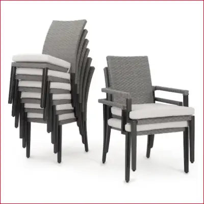 Stacked gray wicker patio chairs with white cushions from the Vistano Dining Set