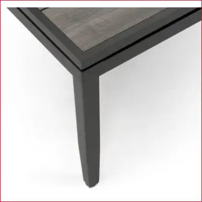 Corner of a gray table from the Vistano Weathered Gray Wicker Patio Dining Set