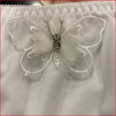 Delicate white butterfly decoration with rhinestone accents on bridal white lace panties