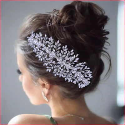 Ornate silver leaf bridal hairpiece enhancing an elegant updo for a wedding dress