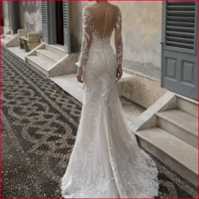 Elegant white lace mermaid styled wedding dress with long sleeves and crystal appliqué