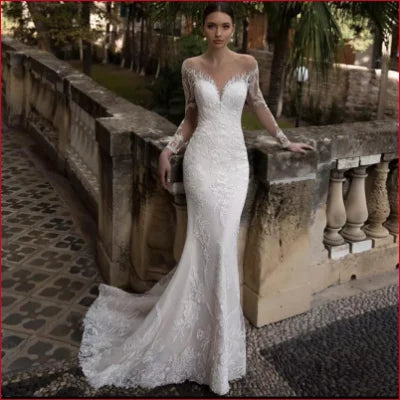 Elegant white lace mermaid styled wedding dress with long sleeves and crystal appliqué