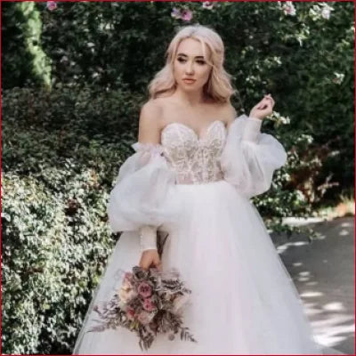 Wedding dress featuring detachable puffy sleeves and a voluminous tulle skirt