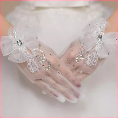 Delicate bridal hand gloves with lace, beads, and bows for elegant wedding accessory