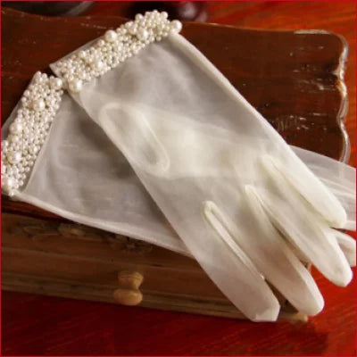 Bridal hand gloves featuring pearl embellishments for an elegant wedding accessory