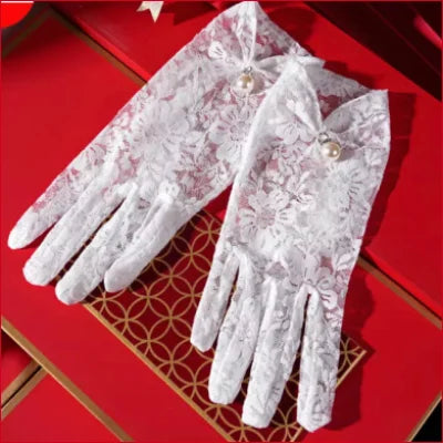 Delicate white lace bridal hand gloves with floral patterns for elegant weddings