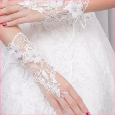 Delicate white lace bridal hand gloves with floral embroidery for elegant weddings