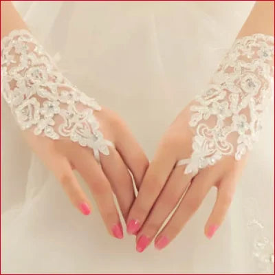 Delicate bridal hand gloves with lace, showcasing hands and pink manicured nails