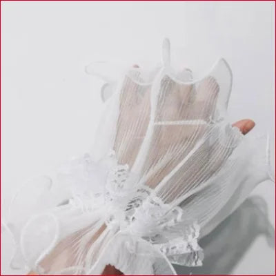 Delicate white lace glove on hand with Steampunk-Inspired Horn Bridal Wrist Cuffs