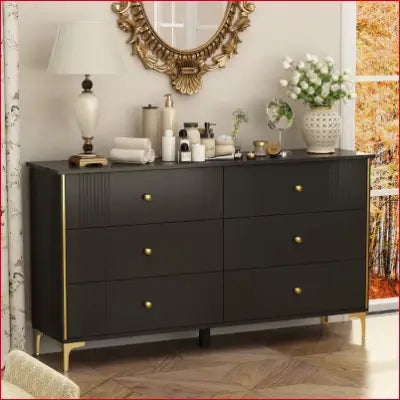 Black standard dresser with gold accents, perfect for storing wedding dresses and accessories