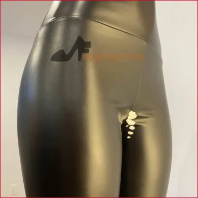 Shiny black mannequin legs showcasing handmade white stained black vegan leather leggings