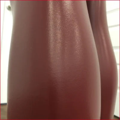 Smooth curved reddish-brown ceramic vase paired with Red Wine Faux Leather Leggings