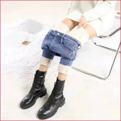 Pair of black leather combat boots with Cozy Slim Fit Fleece Velvet Lined Women’s Jeans