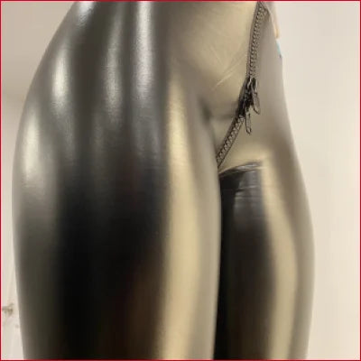 Metallic silver thermos next to Black Leather Crotch Zipper Leggings for a stylish look