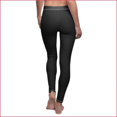 Black elastic skinny fit leggings with all over prints worn by a person from the waist down